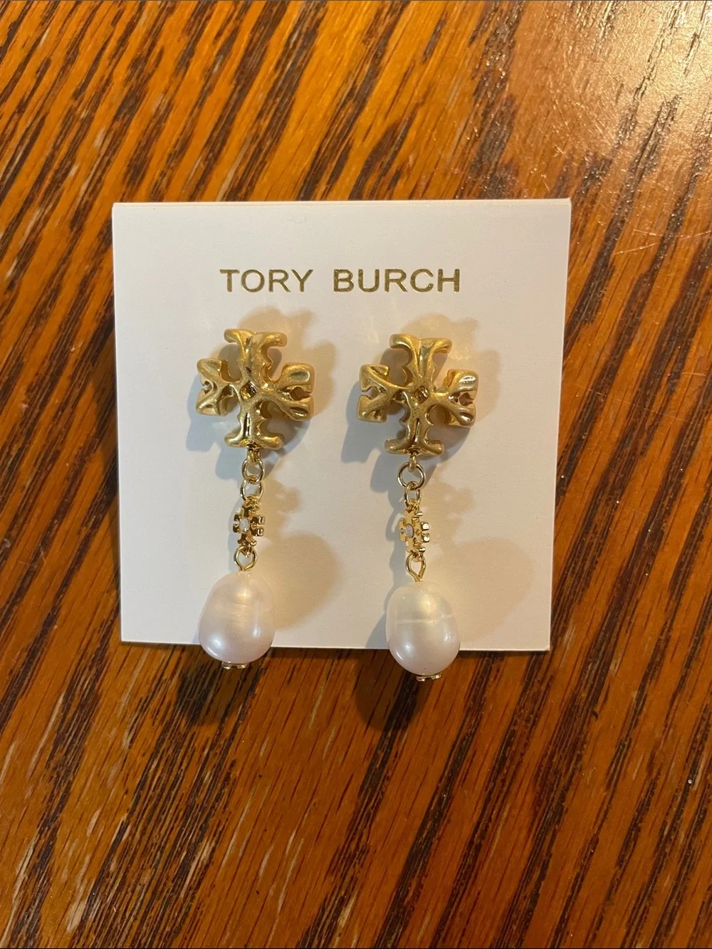Brand new pearl-drop earrings by Tory Burch.